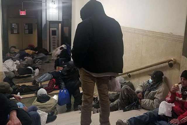Homeless men jammed into entrance of NYC's 30th Street
            shelter, May 2020. (Photo obtained by The City)