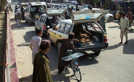 Cars bring bodies of villagers killed by U.S. airstrike in Helmand province to place in front of governor's house, November 5. (Photo: Abdul Khaleq/AP)