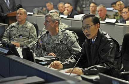 south korean president lee myung-bak donned leather jacket for tough guy image. shown with u.s. gen. walter sharp, commander of u.s. forces in korea, during provocative joint exercises in yellow sea, november 29. in case of hostilities, the u.s. formally commands the republic of korea army.