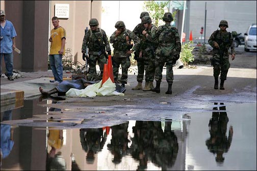 Troops with corpse in New Orleans, 7 Sept. 2005