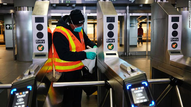 Cleaning NYC subway turnstiles, 6 May 2020 (Photo:
                CNN)